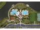 Overhead aerial view of a Primary-planned community with pools, playground, tennis court, parking, and community center by a lake at 10262 Newminster Loop, Ruskin, FL 33573