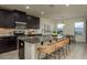 Kitchen island with granite countertops, stainless steel appliances, with seating area and decorative hanging lighting at 10262 Newminster Loop, Ruskin, FL 33573