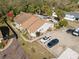 Aerial view of property with ample parking and access to a community pool, highlighted by a red arrow at 104 Anclote Rd # 104, Tarpon Springs, FL 34689