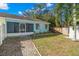 Backyard features a screened patio, rock landscaping, and a shed at 104 Anclote Rd # 104, Tarpon Springs, FL 34689