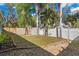 Backyard featuring tropical plants, a shed, and full privacy fencing at 104 Anclote Rd, Tarpon Springs, FL 34689