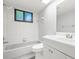 Bathroom with white tile and a tub at 104 Anclote Rd # 104, Tarpon Springs, FL 34689