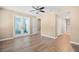 Light bedroom featuring wood flooring, closet and glass doors to another room at 104 Anclote Rd # 104, Tarpon Springs, FL 34689