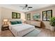 Serene bedroom featuring black trimmed windows, light wood floors, and stylish decor at 104 Anclote Rd # 104, Tarpon Springs, FL 34689