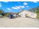Exterior view of property with ample parking space and well-maintained landscaping at 104 Anclote Rd # 104, Tarpon Springs, FL 34689