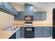 Well-lit kitchen featuring stainless steel appliances and ample countertop space for meal preparation at 104 Anclote Rd # 104, Tarpon Springs, FL 34689