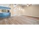 Open-concept living area with wood-look floors, natural light, and a partial kitchen view at 104 Anclote Rd # 104, Tarpon Springs, FL 34689