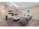 Bright living room with modern decor, skylight, ceiling fan, and glass doors to the outdoor space at 104 Anclote Rd, Tarpon Springs, FL 34689