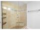 Tiled shower with glass enclosure and built-in shelves at 104 Anclote Rd # 104, Tarpon Springs, FL 34689