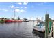 Beautiful waterfront view featuring several docks with fishing boats under a partly cloudy sky at 104 Anclote Rd # 104, Tarpon Springs, FL 34689