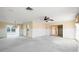 Open living area with ceiling fan and expansive windows overlooking the waterfront view at 10427 Spoonbill W Rd, Bradenton, FL 34209
