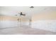 Spacious living room featuring a ceiling fan and an open floor plan ready for renovation at 10427 Spoonbill W Rd, Bradenton, FL 34209