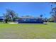 Fenced backyard and patio with picnic table and a lush green lawn at 1111 Durant Rd, Brandon, FL 33511