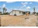 Backyard view of the home featuring a screened-in porch, exterior access and yard at 1118 Excalibur St, Holiday, FL 34690