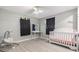 Bedroom with light gray laminate flooring, modern furniture, and whimsical wall decorations at 1118 Excalibur St, Holiday, FL 34690
