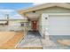 View of front door and attached garage with small statue at 1118 Excalibur St, Holiday, FL 34690