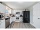 Charming kitchen featuring white cabinets, stainless appliances, and easy access to the side door at 1118 Excalibur St, Holiday, FL 34690