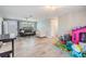 Open living room with wood-look floors, an entry door, and comfortable seating at 1118 Excalibur St, Holiday, FL 34690