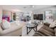 Inviting living room with access to lanai, open kitchen view, and comfortable seating area at 1118 Excalibur St, Holiday, FL 34690