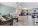 Open concept floorplan with light wood floors, a ceiling fan, and plenty of natural light at 1118 Excalibur St, Holiday, FL 34690