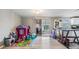 Bright living area with open patio access, play area, and light-colored walls at 1118 Excalibur St, Holiday, FL 34690