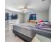 Spacious main bedroom with a ceiling fan, two windows, and light gray laminate flooring at 1118 Excalibur St, Holiday, FL 34690