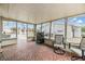 Enclosed sunroom with tile flooring, grill, and views of the surrounding neighborhood at 1118 Excalibur St, Holiday, FL 34690