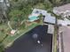 An aerial view of community amenities including a pool, gazebo, pond with fountain and outdoor recreation areas at 11266 Kapok Grand Cir, Madeira Beach, FL 33708