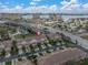 An aerial view of charming townhomes featuring private driveways, tropical landscaping, and city views at 11266 Kapok Grand Cir, Madeira Beach, FL 33708