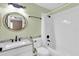 Bathroom with tiled shower and floor, and stylish granite vanity at 11266 Kapok Grand Cir, Madeira Beach, FL 33708