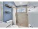 Bathroom shower featuring tiled walls and floors, as well as storage shelves at 11266 Kapok Grand Cir, Madeira Beach, FL 33708