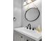 Bathroom featuring a decorative round mirror at 11266 Kapok Grand Cir, Madeira Beach, FL 33708
