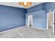 Bedroom featuring a large closet, carpet, and blue wall at 11266 Kapok Grand Cir, Madeira Beach, FL 33708