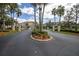 Gated community entrance featuring meticulously maintained landscaping and well manicured grounds at 11266 Kapok Grand Cir, Madeira Beach, FL 33708