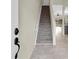 Entry hallway with a staircase and an open view of the living area at 11266 Kapok Grand Cir, Madeira Beach, FL 33708