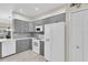 Modern kitchen with stainless steel appliances, gray cabinets, and a pantry at 11266 Kapok Grand Cir, Madeira Beach, FL 33708