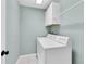 Laundry room with overhead cabinets and white washer-dryer at 11266 Kapok Grand Cir, Madeira Beach, FL 33708