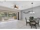 Open living area with ceiling fan and sliding doors leading to the screened porch at 11266 Kapok Grand Cir, Madeira Beach, FL 33708