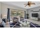 Open-concept living room with nice furniture and screened patio access at 11266 Kapok Grand Cir, Madeira Beach, FL 33708