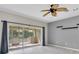 Bright living room with sliding doors leading to the screened porch at 11266 Kapok Grand Cir, Madeira Beach, FL 33708