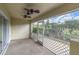 Enclosed outdoor patio with ceiling fans and garden view at 11266 Kapok Grand Cir, Madeira Beach, FL 33708