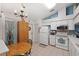 Inviting kitchen area with white appliances, tile floors, and a chandelier over the breakfast table at 11508 Smokethorn Dr, Riverview, FL 33579