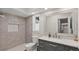 Bathroom with gray tile, a glass-enclosed shower, and modern vanity at 1177 86Th N Ter, St Petersburg, FL 33702