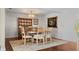 Traditional dining room features a round table, wood hutch, decorative plates, and hardwood floors at 1177 86Th N Ter, St Petersburg, FL 33702