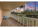 Inviting balcony with two blue chairs and a white railing overlooking lush landscaping at 1200 N Shore Ne Dr # 102, St Petersburg, FL 33701