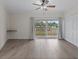 This bright, spacious bedroom features luxury vinyl flooring, slider doors to the patio, and a ceiling fan at 1200 N Shore Ne Dr # 102, St Petersburg, FL 33701