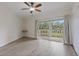 This bright, spacious bedroom features luxury vinyl flooring, slider doors to the patio, and a ceiling fan at 1200 N Shore Ne Dr # 102, St Petersburg, FL 33701