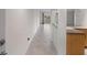 View of the home's hallway with diagonally-laid tile floor leading to the outdoor balcony at 1200 N Shore Ne Dr # 102, St Petersburg, FL 33701