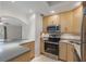 Bright, modern kitchen featuring stainless steel appliances, light wood cabinets and tile backsplash at 1200 N Shore Ne Dr # 102, St Petersburg, FL 33701