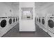 Clean, shared laundry room with rows of modern washing machines for resident convenience at 1200 N Shore Ne Dr # 102, St Petersburg, FL 33701